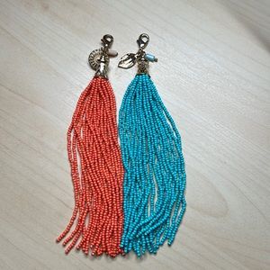 Turquoise and orange tassels. Clip to anything you like!